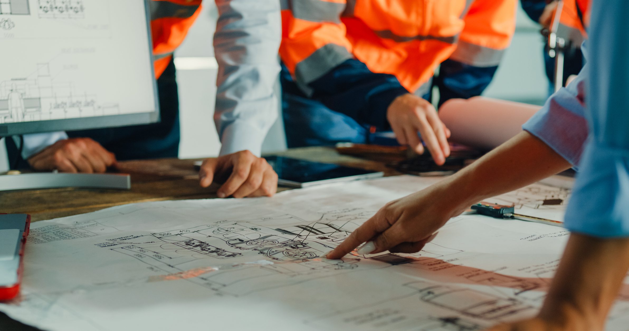 Closeup of team of engineers meeting to analyze blueprints Closeup of team of engineers meeting to analyze blueprints